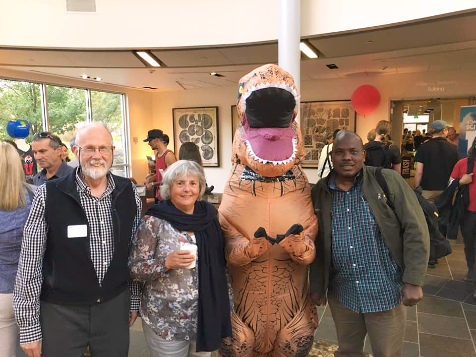 Faculty and an inflatible dinosaur