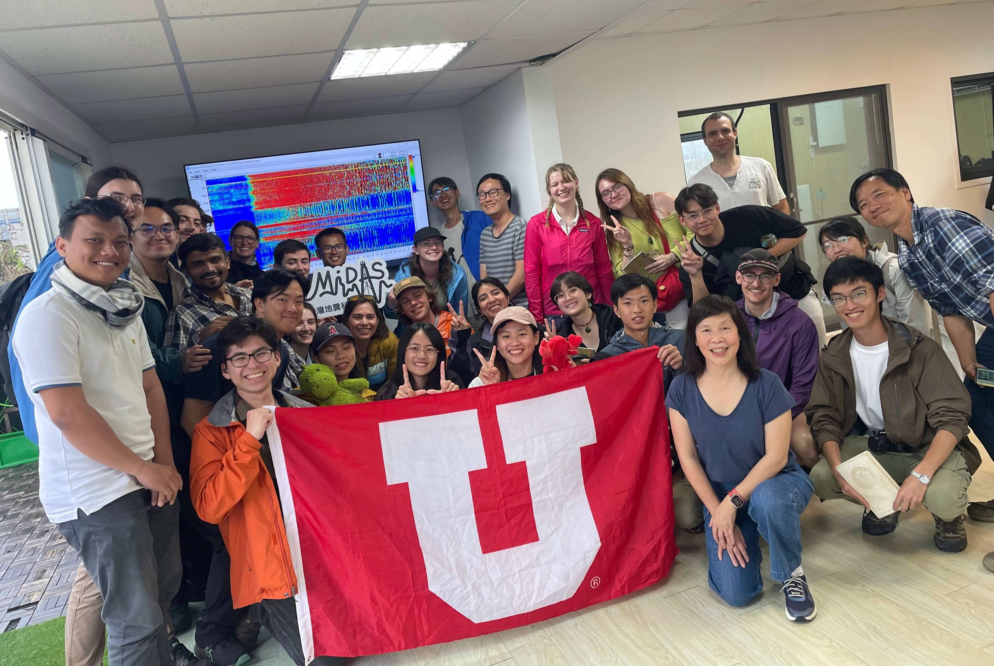 Students posing with U flag