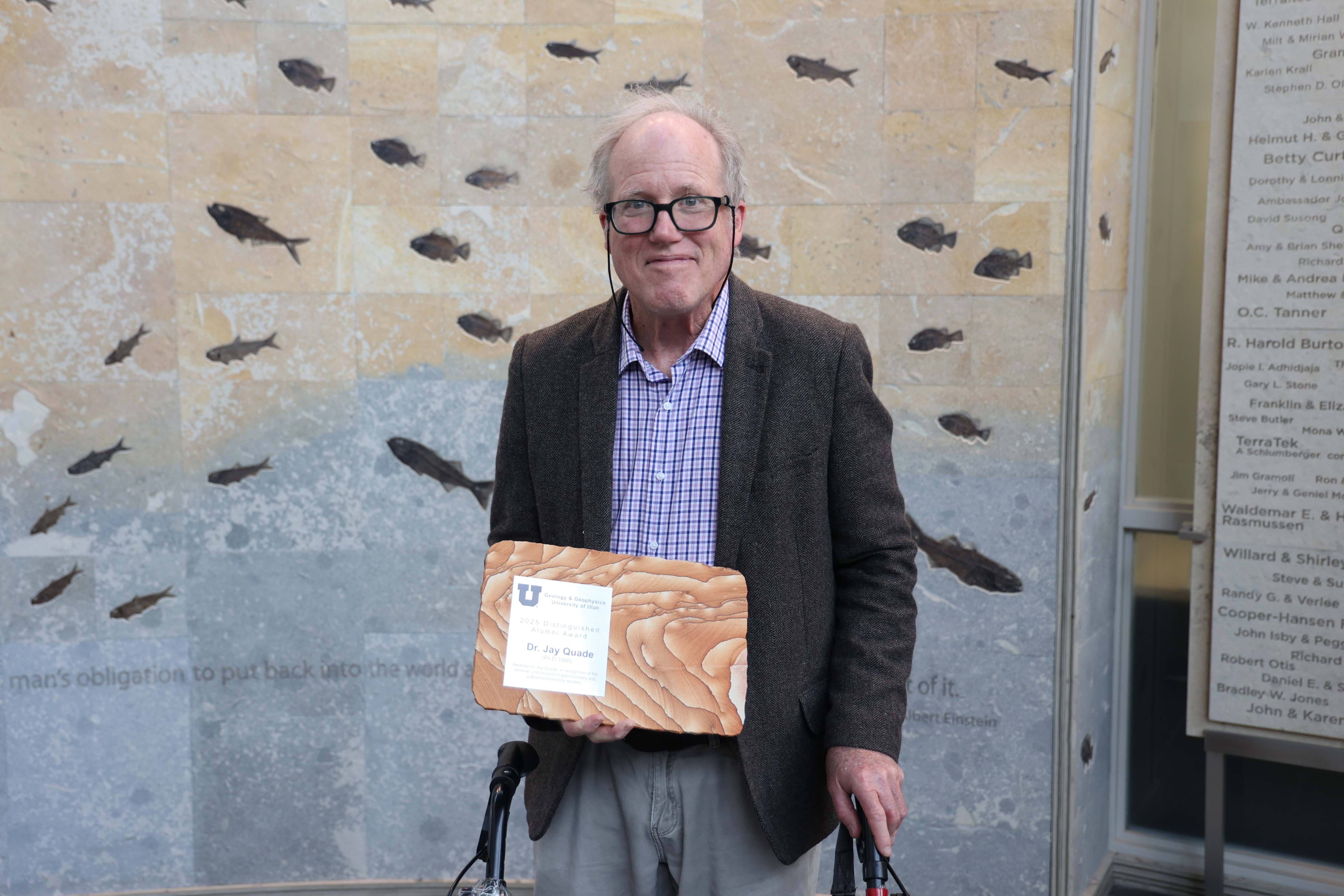 Jay Quade holding award.