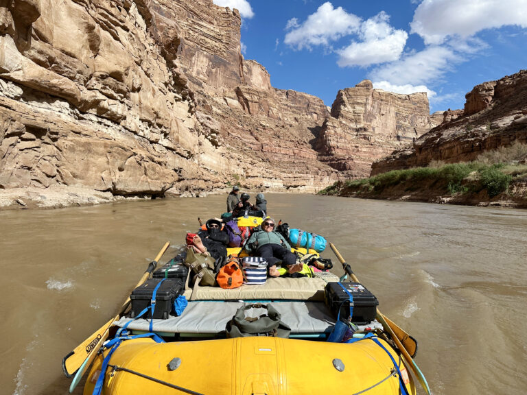 Brenda Bowen in a raft on a river.